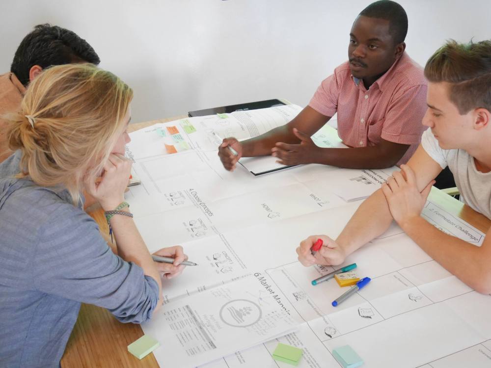 Team reviewing engineering drawings together during a training session.