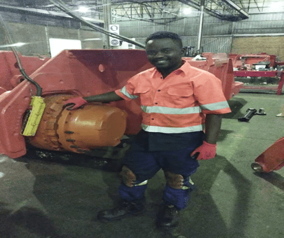 Technician working on a mining machine component during the equipment rebuild process.