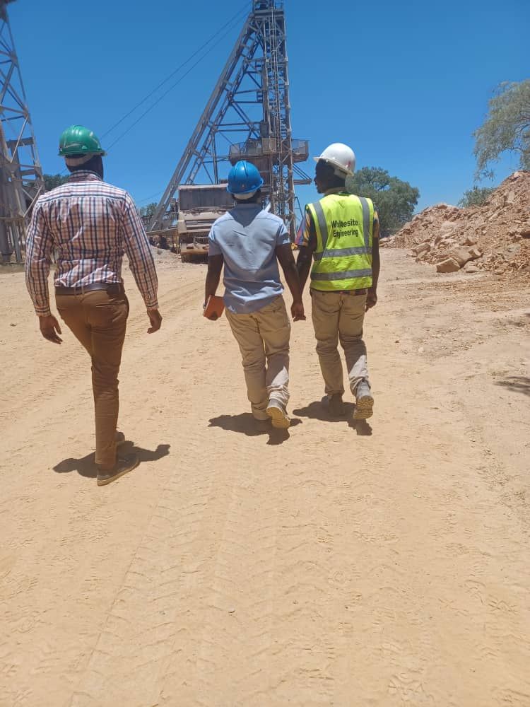 Engineers walking across a mining structural project site.