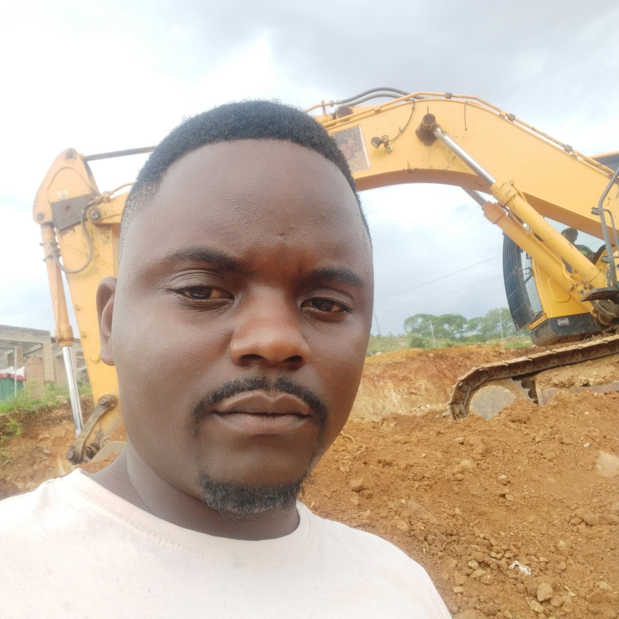 Engineer on-site with heavy earthmoving equipment during a support engagement.