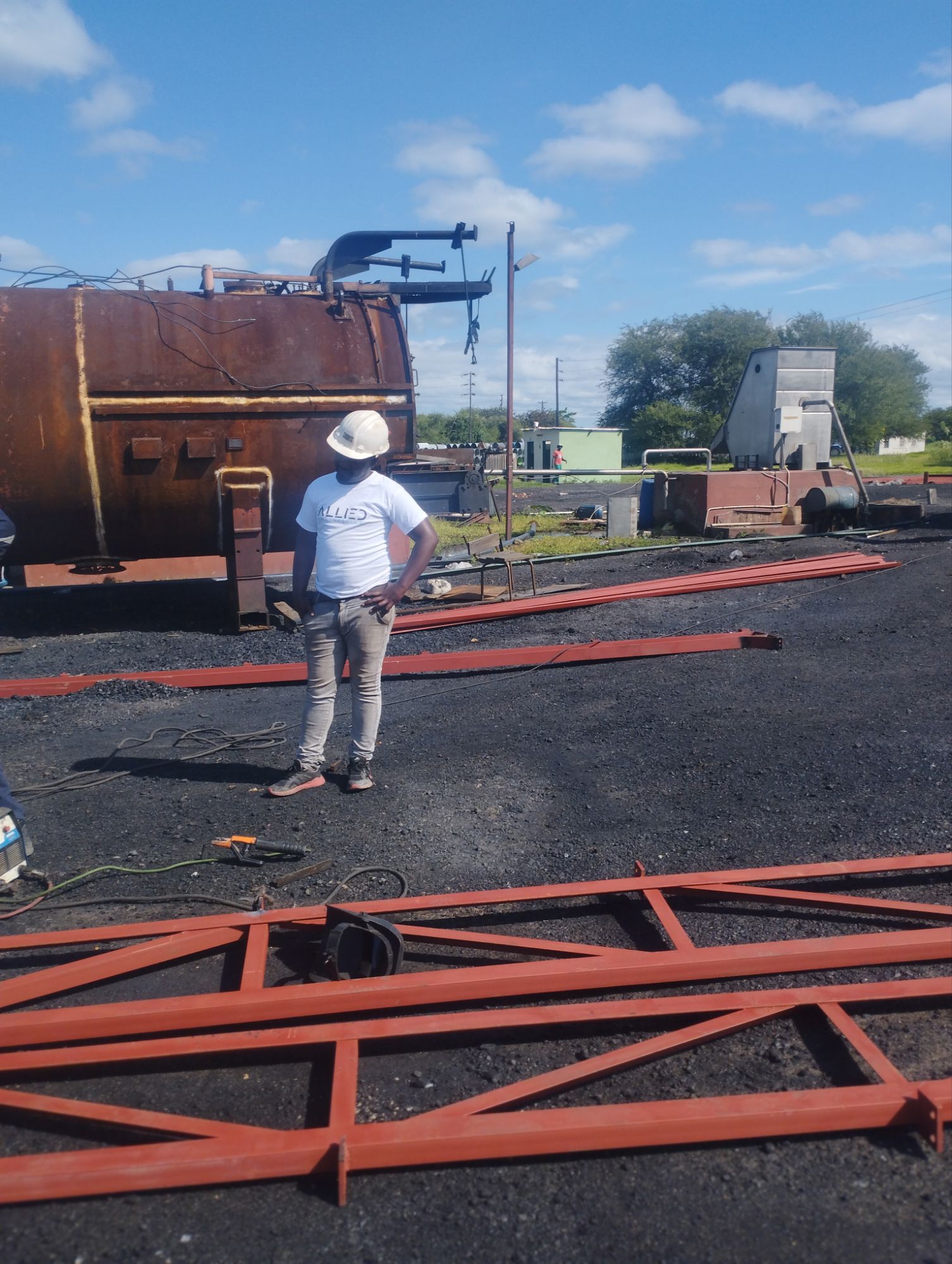 Engineer inspecting red steel piping structure on a structural project site.