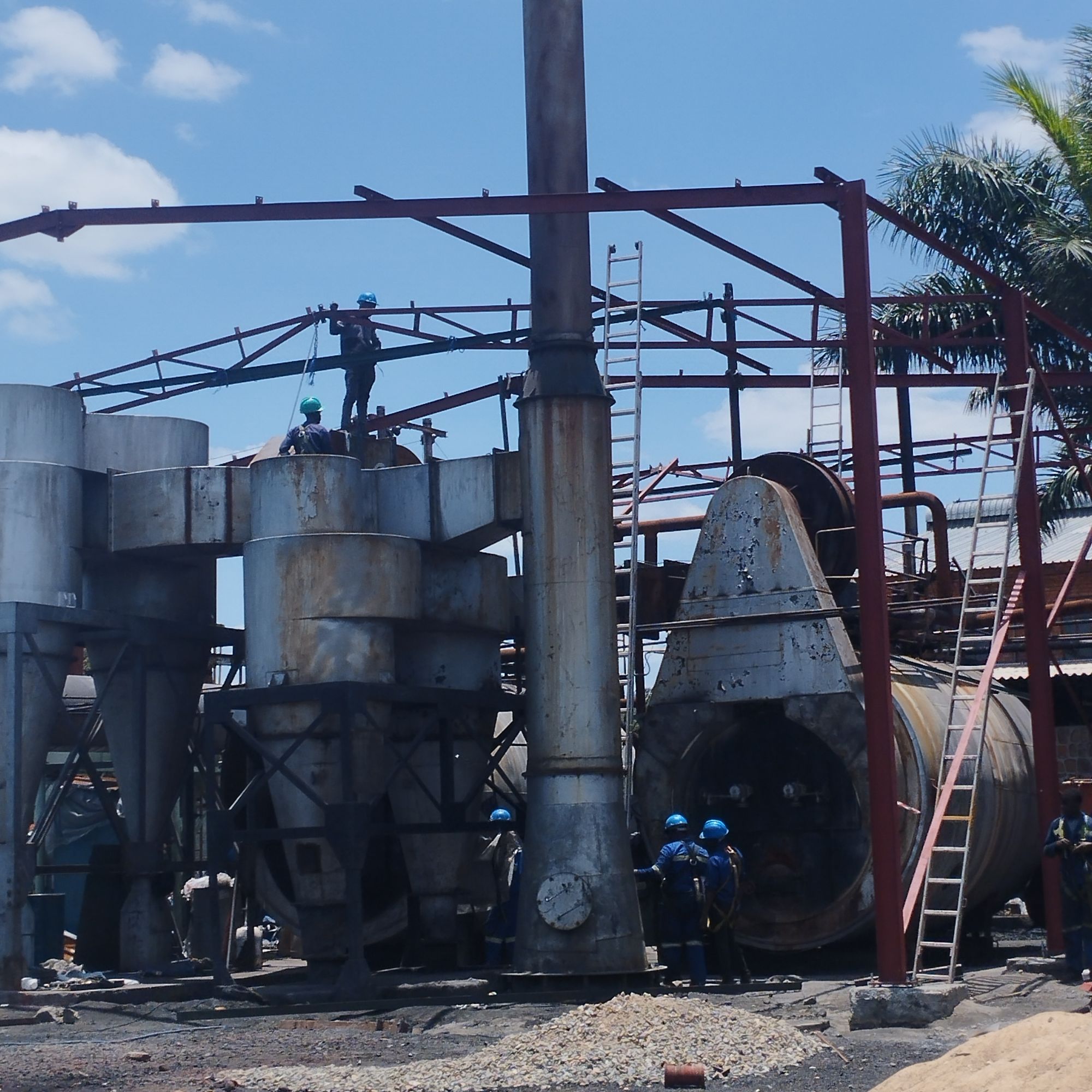 Steel-framed industrial structure with vertical cylindrical process tanks on a structural engineering project.